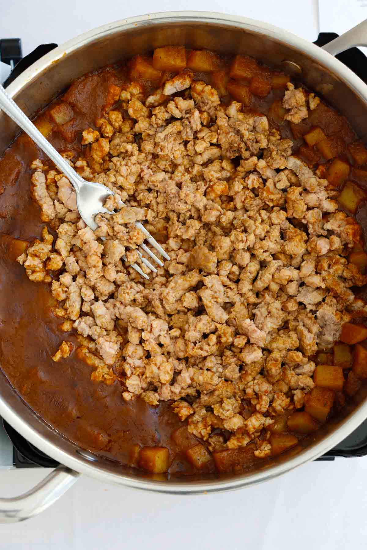 Ground pork tacos Mexican recipe - breaking down the ground pork in the pan.