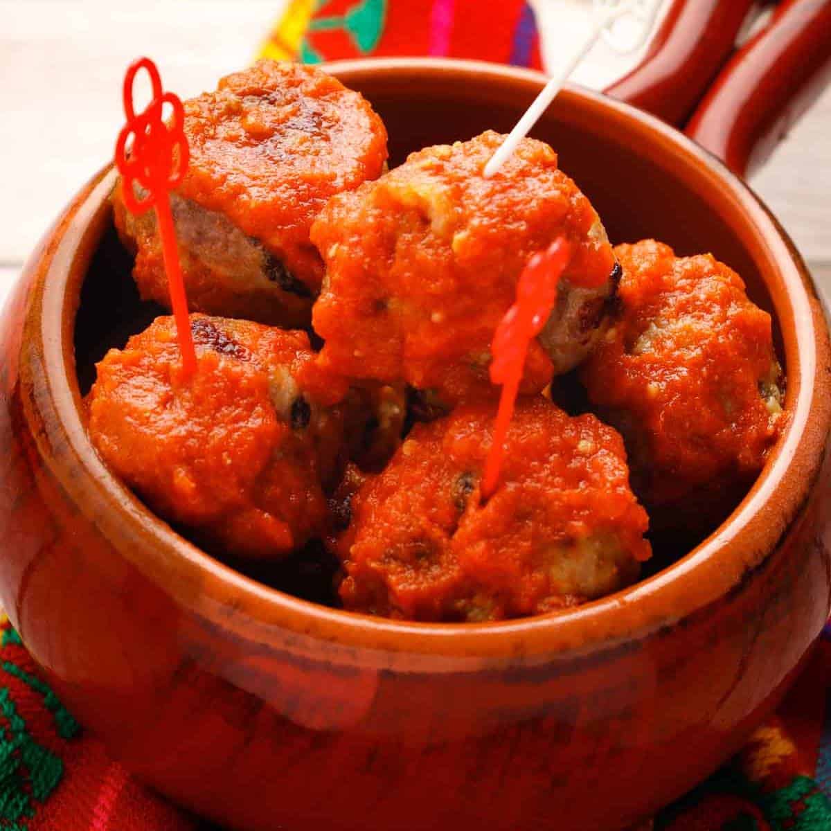 Baked Mexican meatballs with sauce in a bowl.