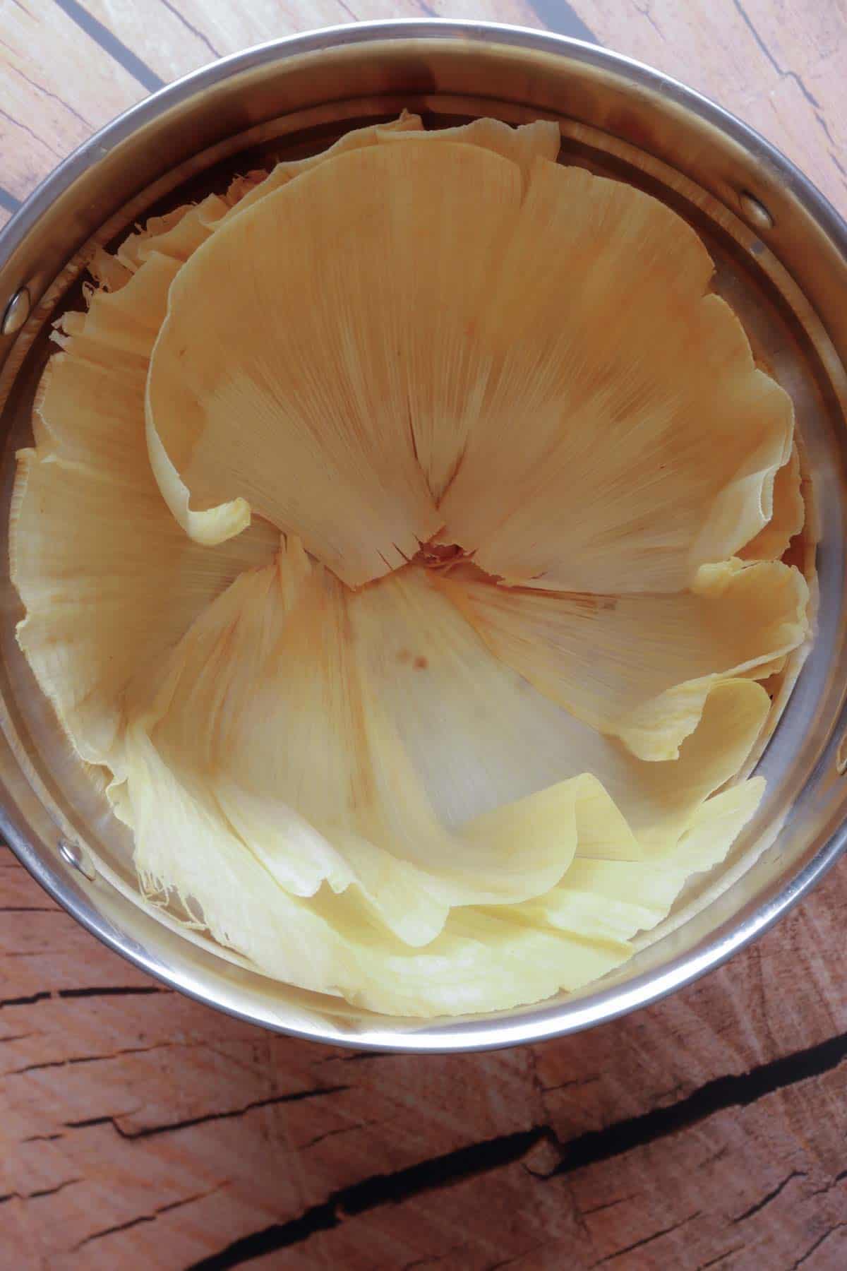 Base of corn husks inside the tamales or tall pot.