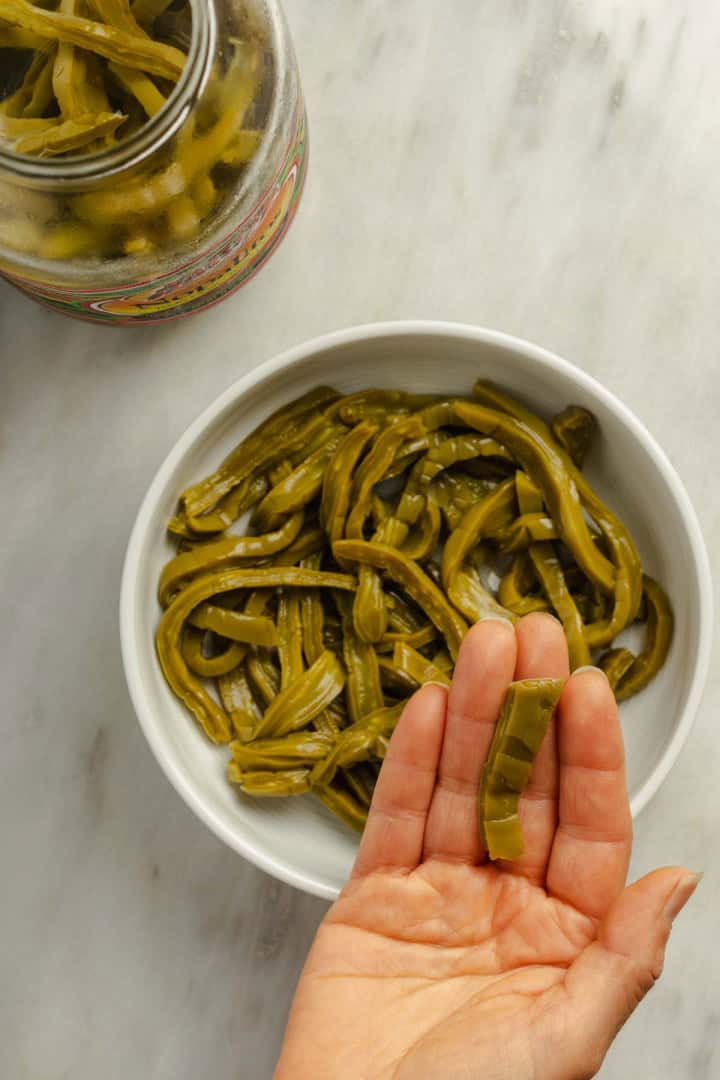 Jarred (canned) nopales (cactus paddles) placed in a white bowl.
