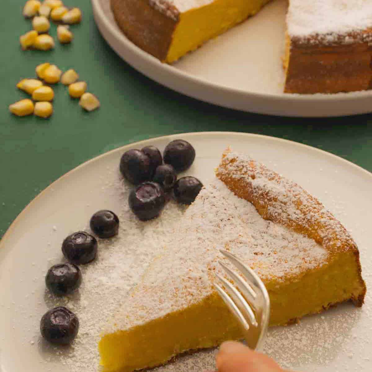 Mexican sweet corn cake - Pan de Elote served with blueberries on the side.