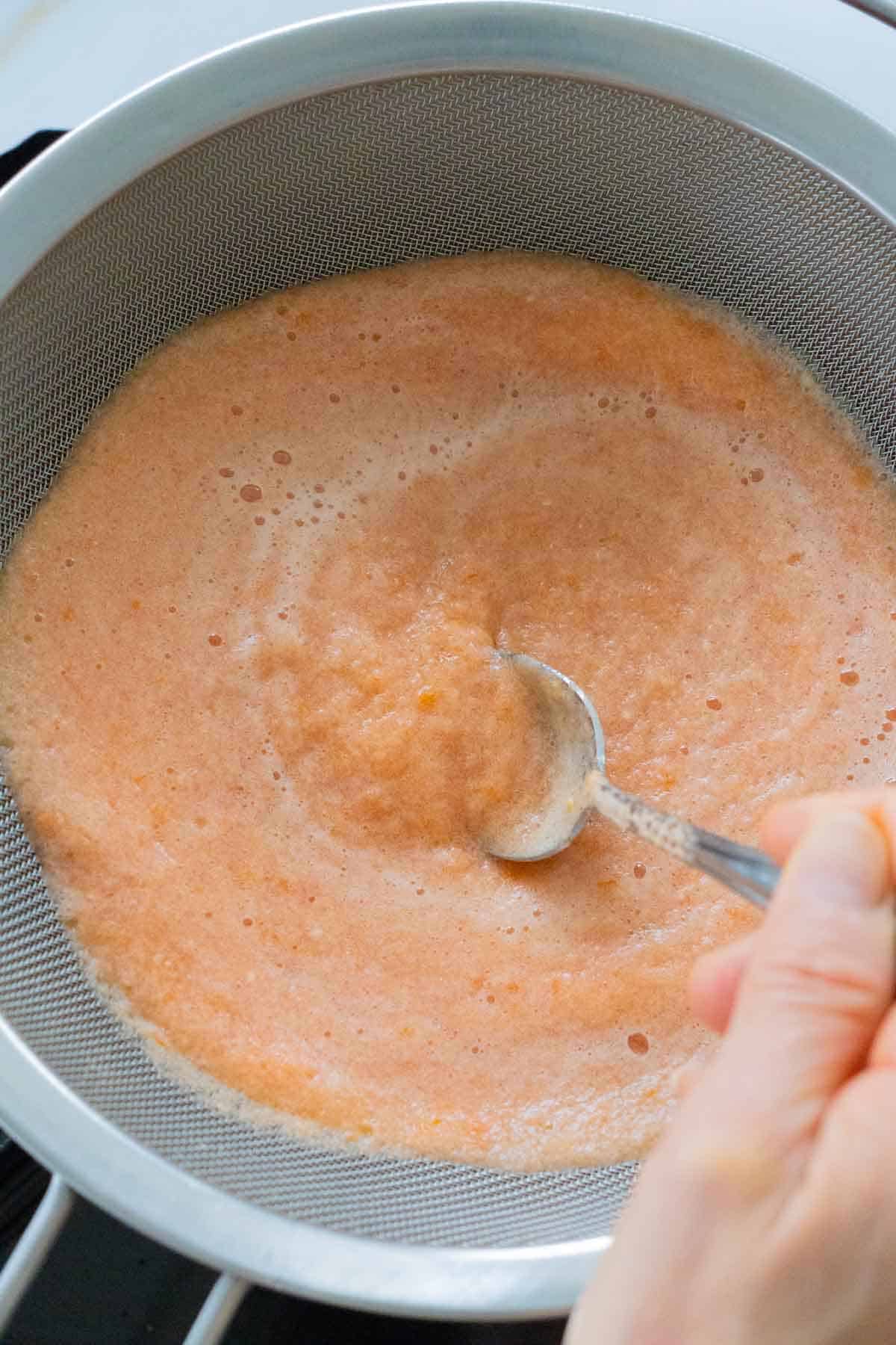 Strainer placed on top of pot with potato and leek soup
