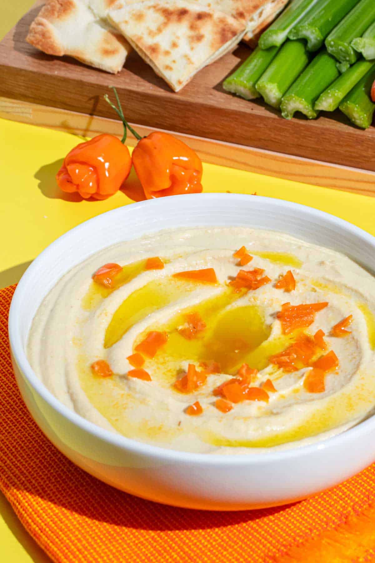 Spicy Hummus with Habanero served with pita bread, celery sticks and baby carrots.