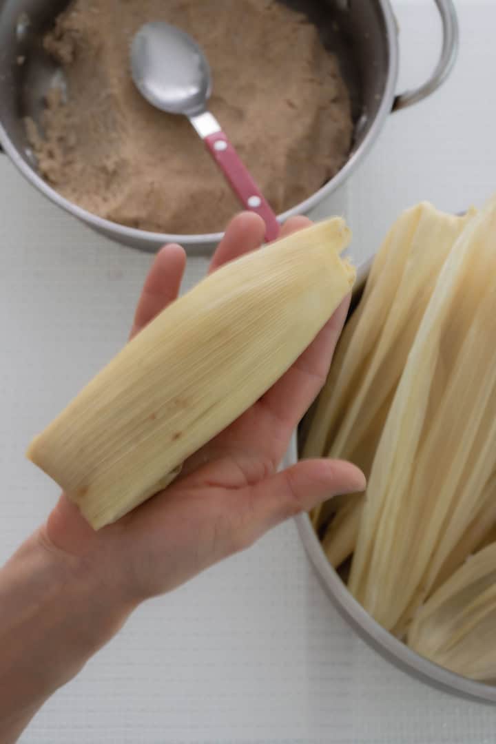 Assembling-the-tamales-tip-end-folded-for-Beans-and-cheese-tamales.