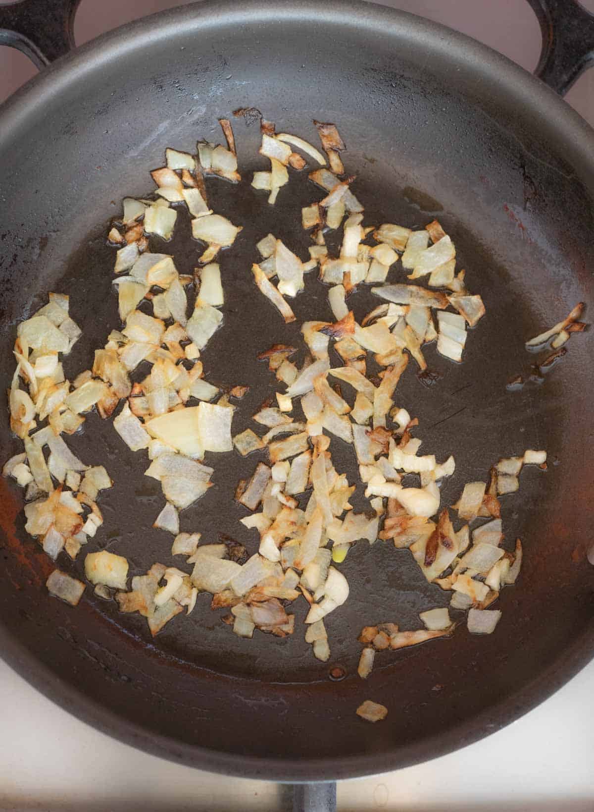 Sauted-garlic-and-onion-for-beans-and-cheese-tamales.