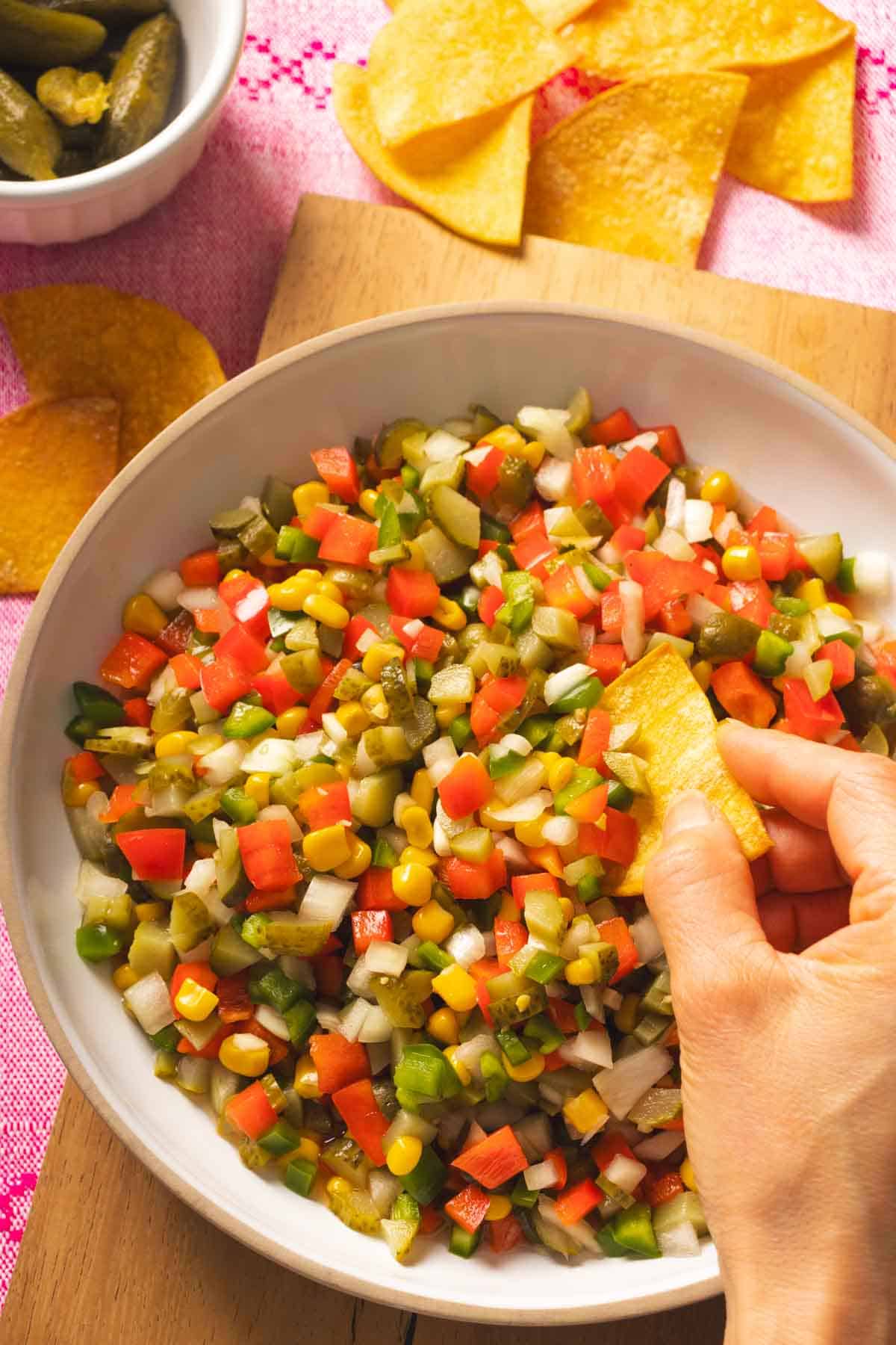 Pickle de Gallo served in a bowl with some tortilla chips on the side.