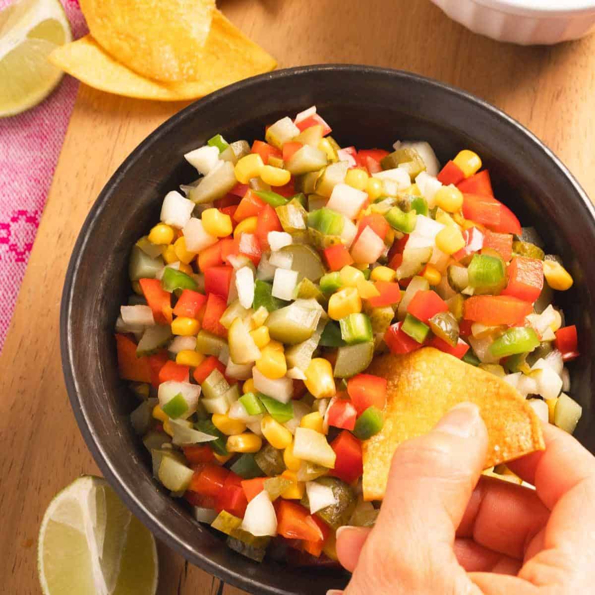 Pickle de Gallo served in a bowl with some tortilla chips on the side.