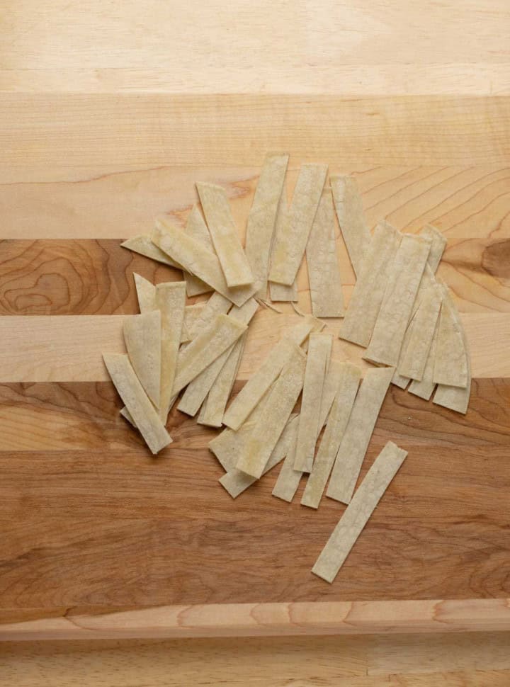 Tortilla cut into ยฝ IN strips.