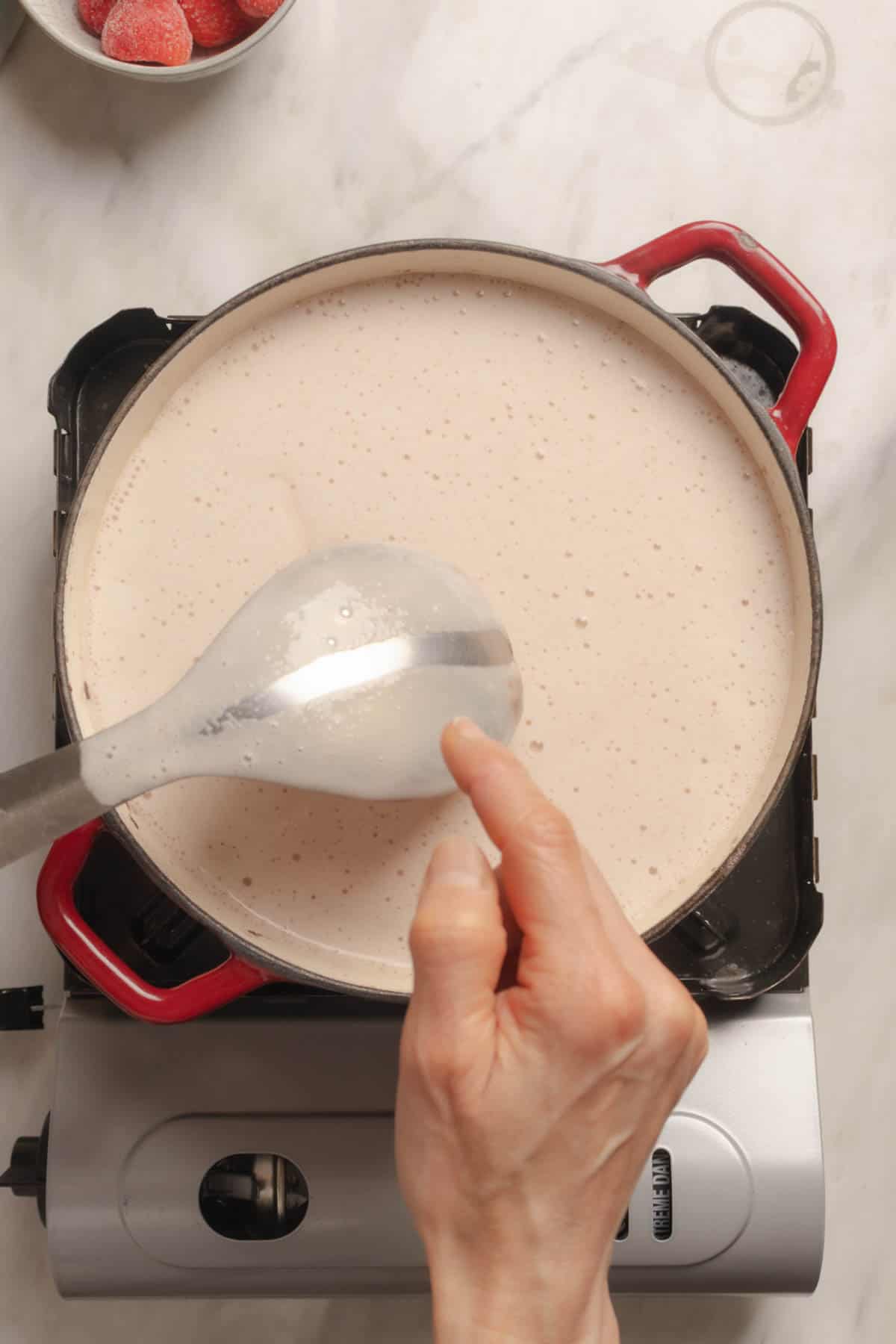 Strawberry Atole - ready when it coats the back of a spoon.