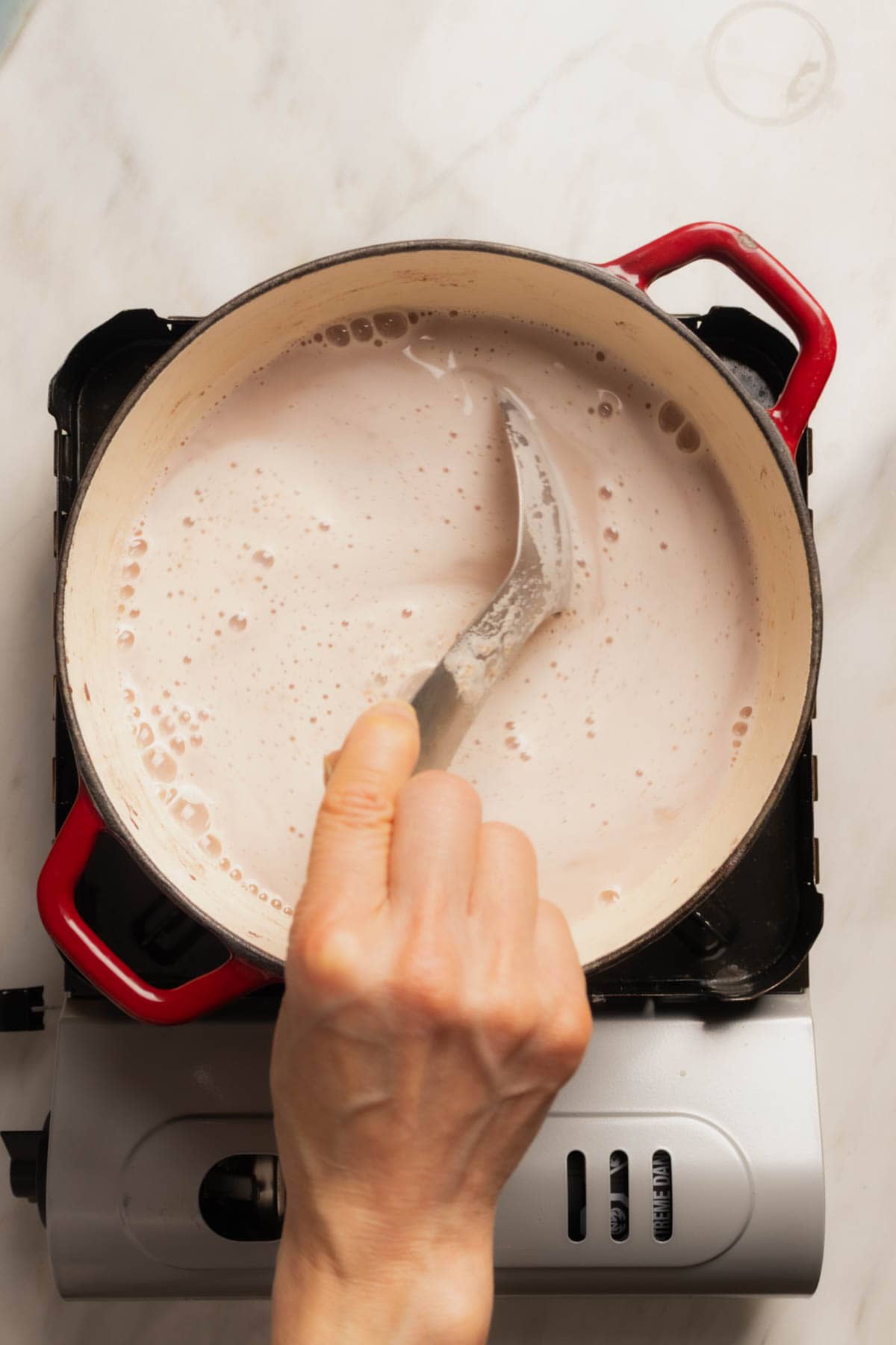 Strawberry Atole - stirring the atole