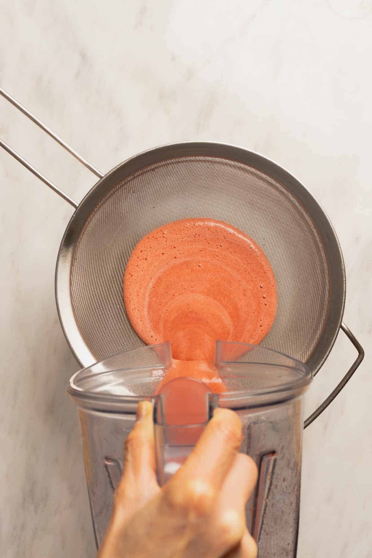 Strawberry Atole - straining strawberries