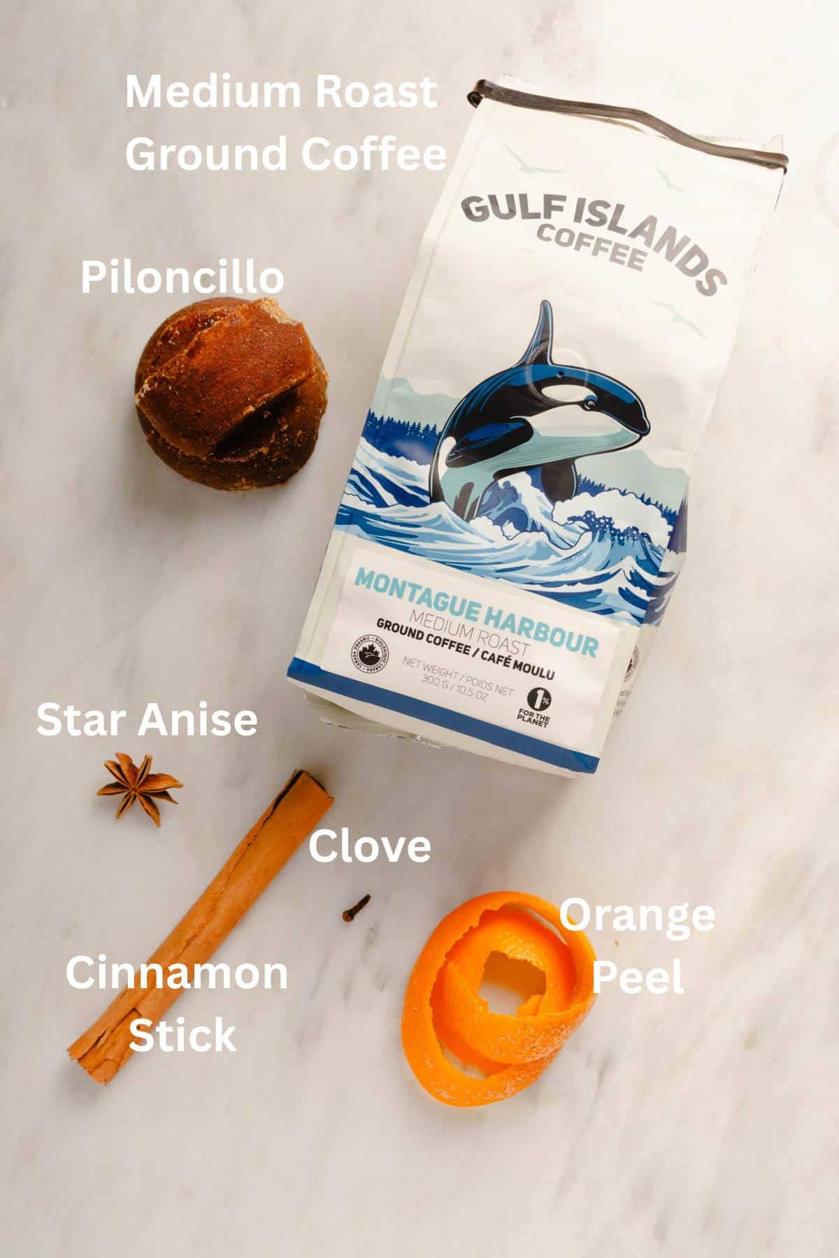 Ingredients for making Café de Olla: Piloncillo, medium roast ground coffee, star anise, cinnamon stick, and orange peel.