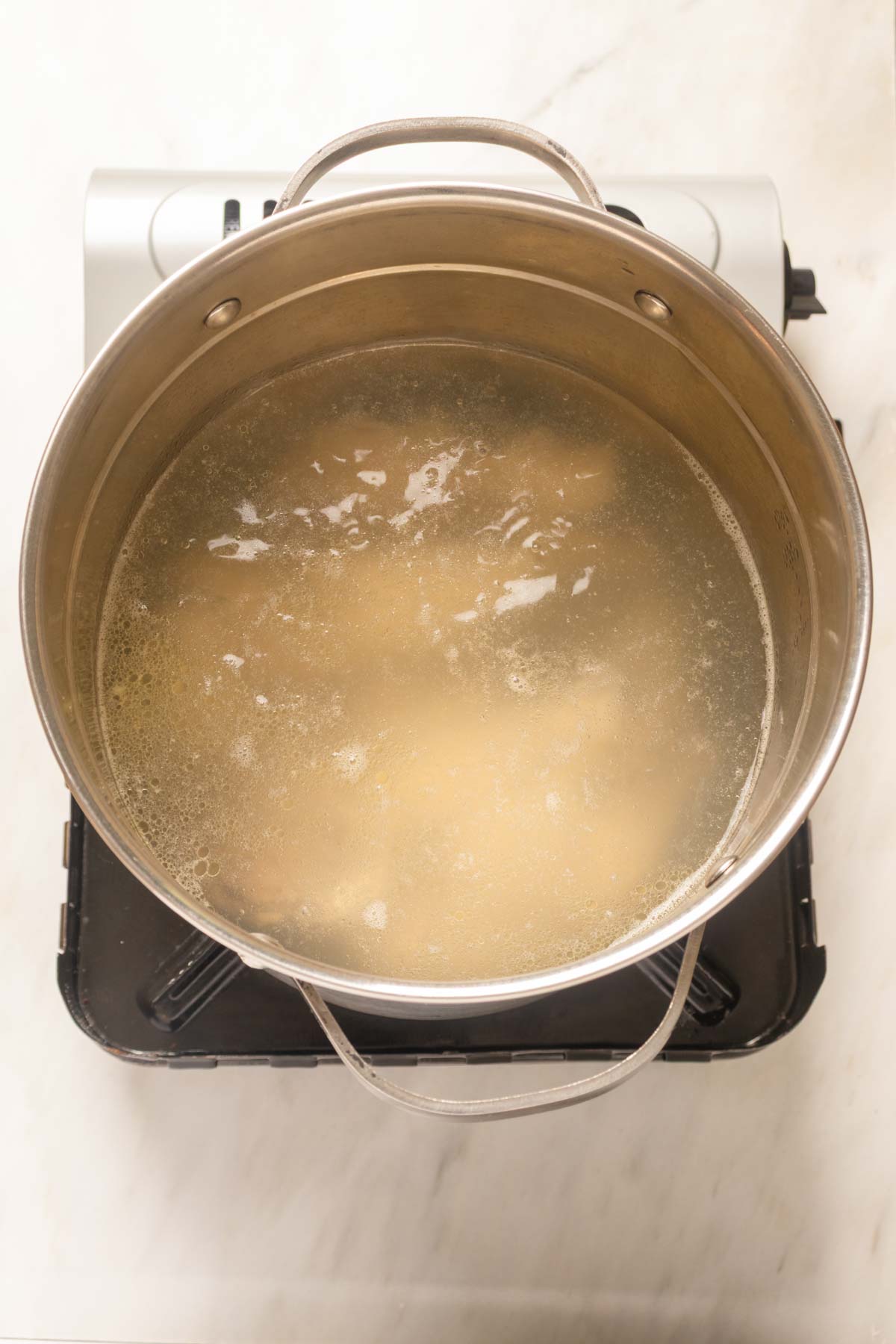 Blanching the chicken in a pot.