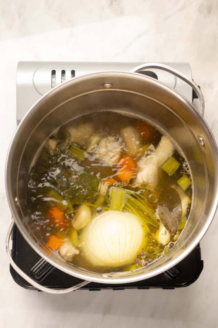 Cooking the chicken broth in a pot.